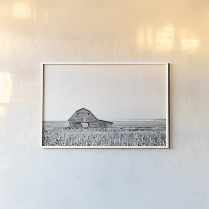 Leaning Barn BW by Nathan Larson. shown as a paper print in a white frame. Available as a archival giclee rolled canvas, fine art paper, or poster print. SKU 86064i.