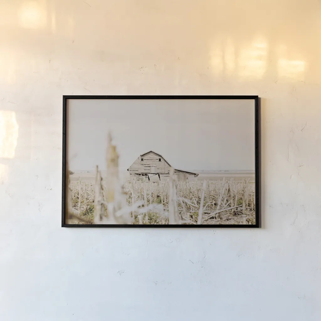 Leaning Barn Field I by Nathan Larson. shown as a paper print in a black flame. Available as a archival giclee rolled canvas, fine art paper, or poster print. SKU 86060i.
