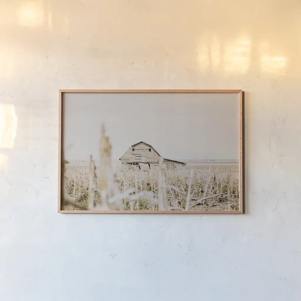 Leaning Barn Field I by Nathan Larson. shown as a paper print in a natural frame. Available as a archival giclee rolled canvas, fine art paper, or poster print. SKU 86060i.