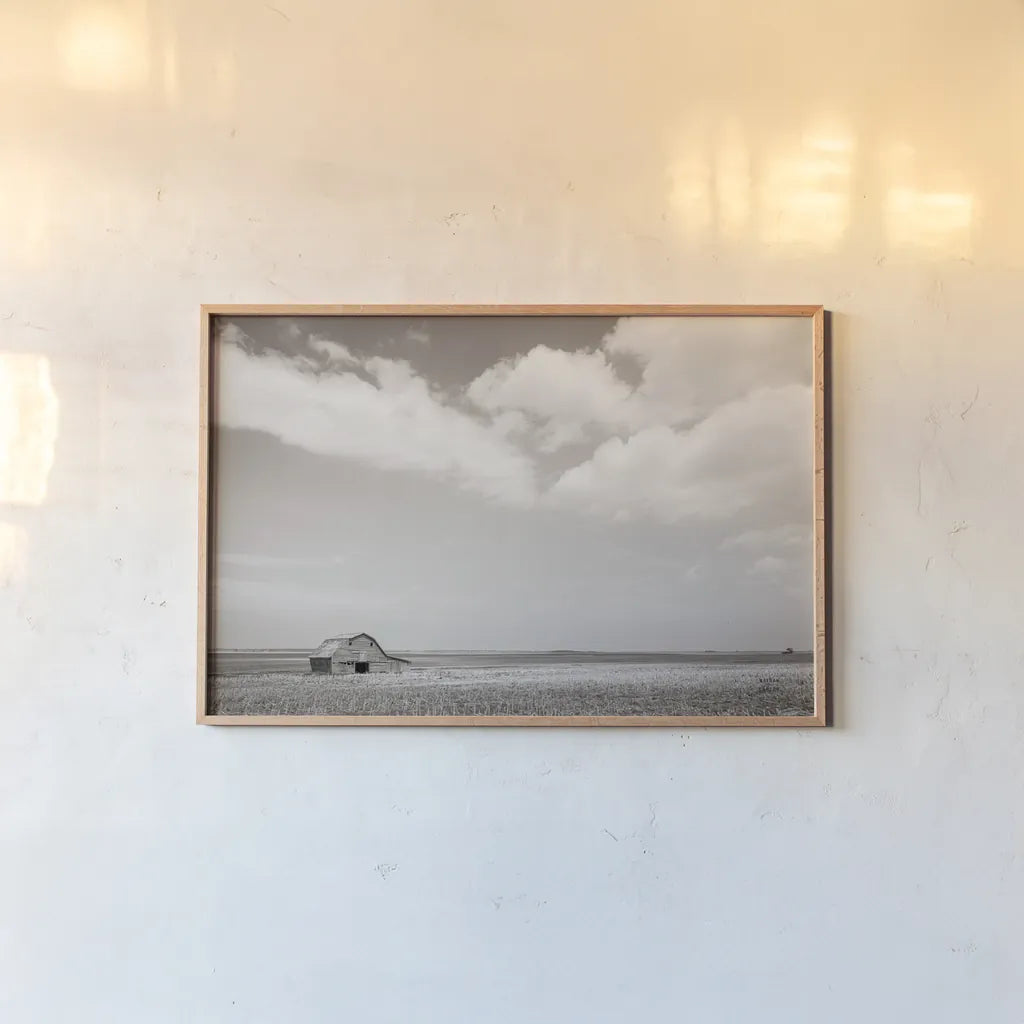 Leaning Barn Field III by Nathan Larson. shown as a paper print in a natural frame. Available as a archival giclee rolled canvas, fine art paper, or poster print. SKU 86073i.