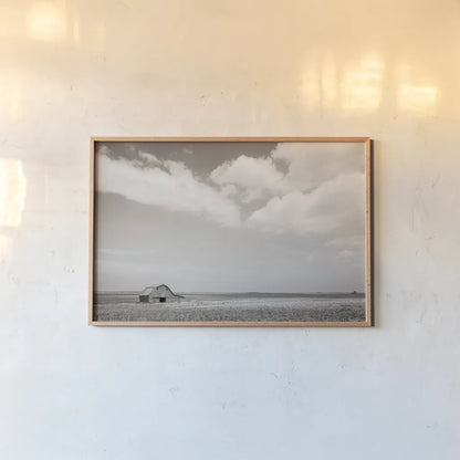 Leaning Barn Field III by Nathan Larson. shown as a paper print in a natural frame. Available as a archival giclee rolled canvas, fine art paper, or poster print. SKU 86073i.