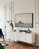 Leaning Barn Neutral by Nathan Larson. shown as a framed stretched canvas in a living room above a console. Available as a archival giclee rolled canvas, fine art paper, or poster print. SKU 86063i.