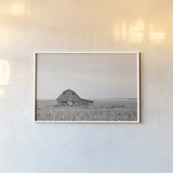 Leaning Barn Neutral by Nathan Larson. shown as a paper print in a white frame. Available as a archival giclee rolled canvas, fine art paper, or poster print. SKU 86063i.