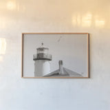 Lighthouse Fly Over by Nathan Larson. shown as a paper print in a natural frame. Available as a archival giclee rolled canvas, fine art paper, or poster print. SKU 87193i.