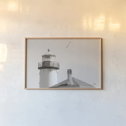 Lighthouse Fly Over by Nathan Larson. shown as a paper print in a natural frame. Available as a archival giclee rolled canvas, fine art paper, or poster print. SKU 87193i.