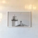 Lighthouse Fly Over by Nathan Larson. shown as a paper print in a white frame. Available as a archival giclee rolled canvas, fine art paper, or poster print. SKU 87193i.