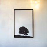 Lone Tree Hill by Nathan Larson. shown as a paper print in a black flame. Available as a archival giclee rolled canvas, fine art paper, or poster print. SKU 71172h.
