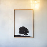 Lone Tree Hill by Nathan Larson. shown as a paper print in a natural frame. Available as a archival giclee rolled canvas, fine art paper, or poster print. SKU 71172h.