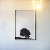 Lone Tree Hill by Nathan Larson. shown as a paper print in a white frame. Available as a archival giclee rolled canvas, fine art paper, or poster print. SKU 71172h.