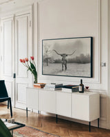 Longhorn Backlit Aged by Nathan Larson. shown as a framed stretched canvas in a living room above a console. Available as a archival giclee rolled canvas, fine art paper, or poster print. SKU 91373i.