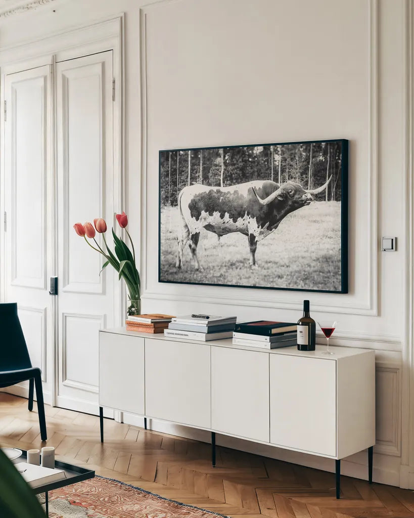 Longhorn Bull BW by Nathan Larson. shown as a framed stretched canvas in a living room above a console. Available as a archival giclee rolled canvas, fine art paper, or poster print. SKU 93354i.