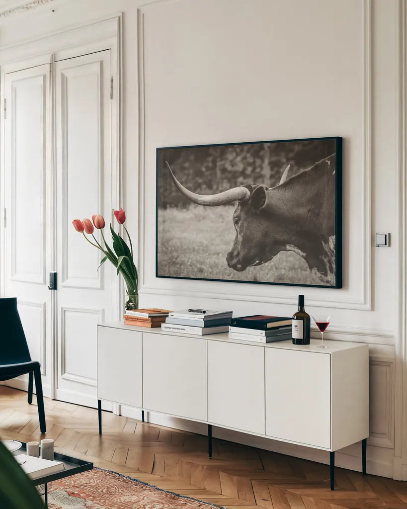 Longhorn Evening Sepia by Nathan Larson. shown as a framed stretched canvas in a living room above a console. Available as a archival giclee rolled canvas, fine art paper, or poster print. SKU 91379i.