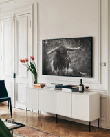 Longhorn Gaze I BW by Nathan Larson. shown as a framed stretched canvas in a living room above a console. Available as a archival giclee rolled canvas, fine art paper, or poster print. SKU 91372i.