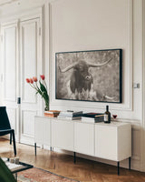 Longhorn Gaze I Sepia by Nathan Larson. shown as a framed stretched canvas in a living room above a console. Available as a archival giclee rolled canvas, fine art paper, or poster print. SKU 91533i.
