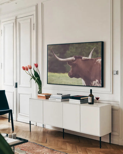 Longhorn Gaze II by Nathan Larson. shown as a framed stretched canvas in a living room above a console. Available as a archival giclee rolled canvas, fine art paper, or poster print. SKU 91531i.