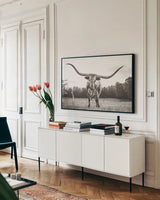 Longhorn Last Call BW by Nathan Larson. shown as a framed stretched canvas in a living room above a console. Available as a archival giclee rolled canvas, fine art paper, or poster print. SKU 91368i.
