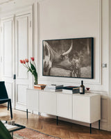 Longhorn Pasture Pair Sepia by Nathan Larson. shown as a framed stretched canvas in a living room above a console. Available as a archival giclee rolled canvas, fine art paper, or poster print. SKU 93357i.