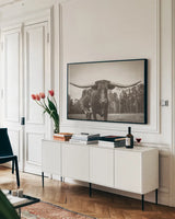 Longhorn Pastures Sepia by Nathan Larson. shown as a framed stretched canvas in a living room above a console. Available as a archival giclee rolled canvas, fine art paper, or poster print. SKU 91380i.
