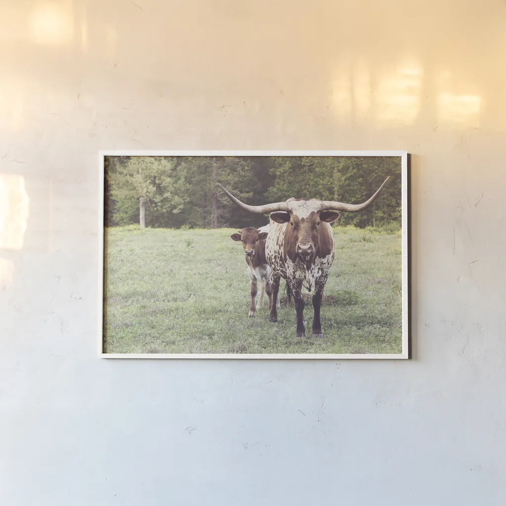 Longhorn Protection by Nathan Larson. shown as a paper print in a white frame. Available as a archival giclee rolled canvas, fine art paper, or poster print. SKU 91520i.