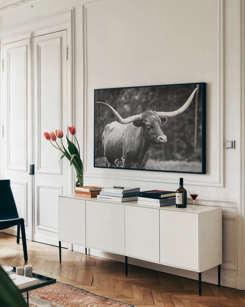 Longhorn Side Eye BW by Nathan Larson. shown as a framed stretched canvas in a living room above a console. Available as a archival giclee rolled canvas, fine art paper, or poster print. SKU 93361i.