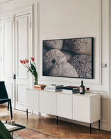 Lost Coast Sea Urchins V by Nathan Larson. shown as a framed stretched canvas in a living room above a console. Available as a archival giclee rolled canvas, fine art paper, or poster print. SKU 96962i.
