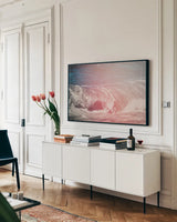 Lost Coast Waves Pink I by Nathan Larson. shown as a framed stretched canvas in a living room above a console. Available as a archival giclee rolled canvas, fine art paper, or poster print. SKU 87260i.