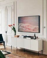 Lost Coast Waves Pink II by Nathan Larson. shown as a framed stretched canvas in a living room above a console. Available as a archival giclee rolled canvas, fine art paper, or poster print. SKU 87261i.