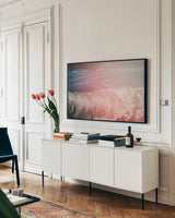 Lost Coast Waves Pink IV by Nathan Larson. shown as a framed stretched canvas in a living room above a console. Available as a archival giclee rolled canvas, fine art paper, or poster print. SKU 87263i.