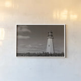 Low Point Lighthouse by Nathan Larson. shown as a paper print in a white frame. Available as a archival giclee rolled canvas, fine art paper, or poster print. SKU 100499i.