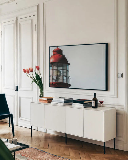 Low Point Lighthouse View by Nathan Larson. shown as a framed stretched canvas in a living room above a console. Available as a archival giclee rolled canvas, fine art paper, or poster print. SKU 100498i.