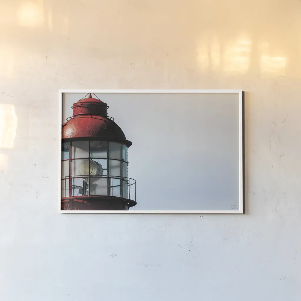Low Point Lighthouse View by Nathan Larson. shown as a paper print in a white frame. Available as a archival giclee rolled canvas, fine art paper, or poster print. SKU 100498i.