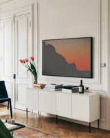 Make Me Your Sunset I by Nathan Larson. shown as a framed stretched canvas in a living room above a console. Available as a archival giclee rolled canvas, fine art paper, or poster print. SKU 82418i.