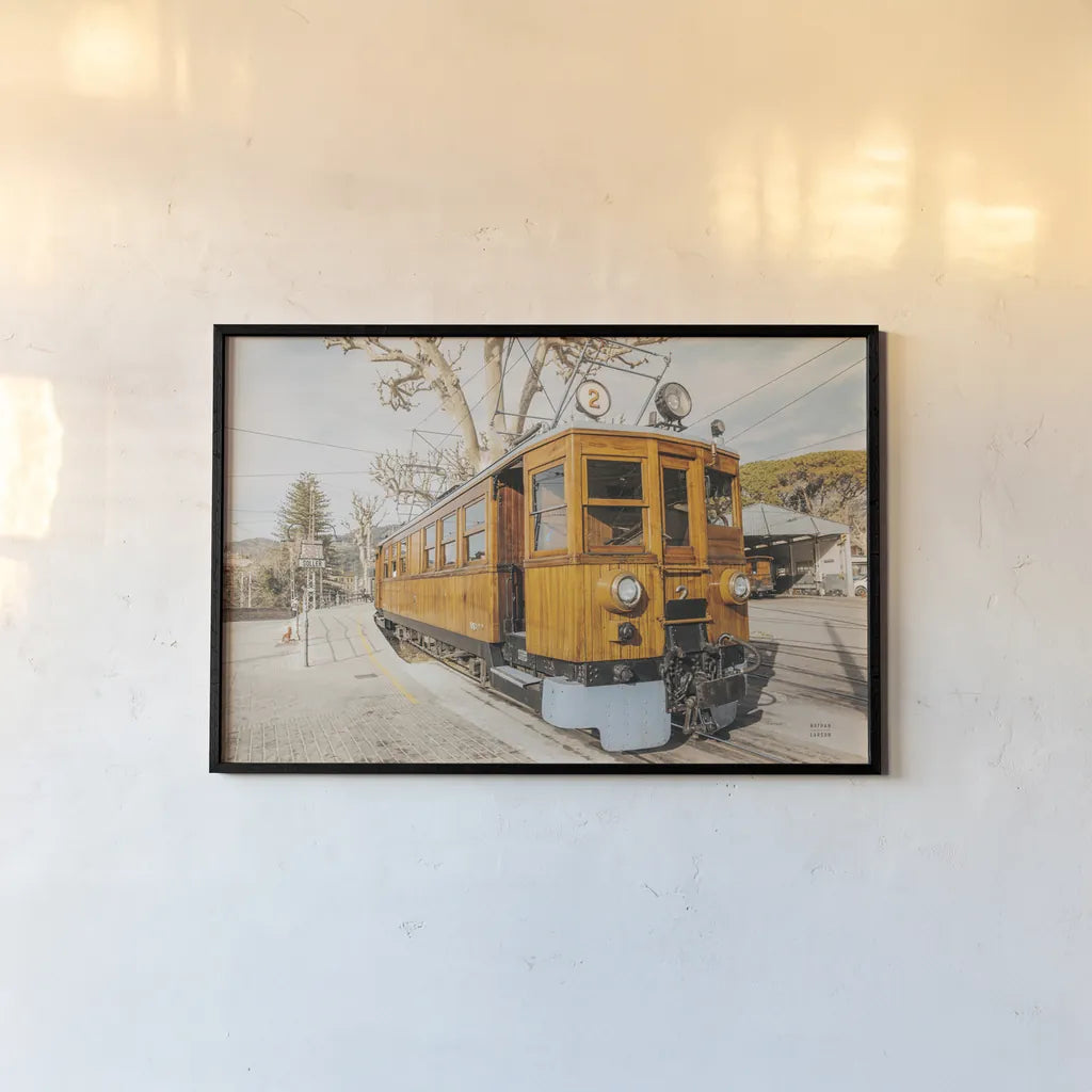 Mallorca Train by Nathan Larson. shown as a paper print in a black flame. Available as a archival giclee rolled canvas, fine art paper, or poster print. SKU 85801i.