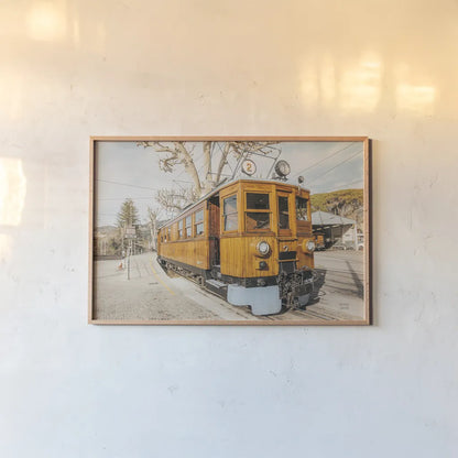 Mallorca Train by Nathan Larson. shown as a paper print in a natural frame. Available as a archival giclee rolled canvas, fine art paper, or poster print. SKU 85801i.