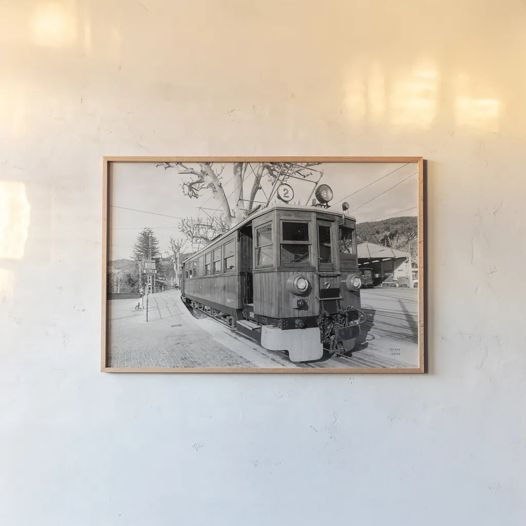 Mallorca Train BW by Nathan Larson. shown as a paper print in a natural frame. Available as a archival giclee rolled canvas, fine art paper, or poster print. SKU 85802i.