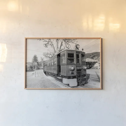 Mallorca Train BW by Nathan Larson. shown as a paper print in a natural frame. Available as a archival giclee rolled canvas, fine art paper, or poster print. SKU 85802i.