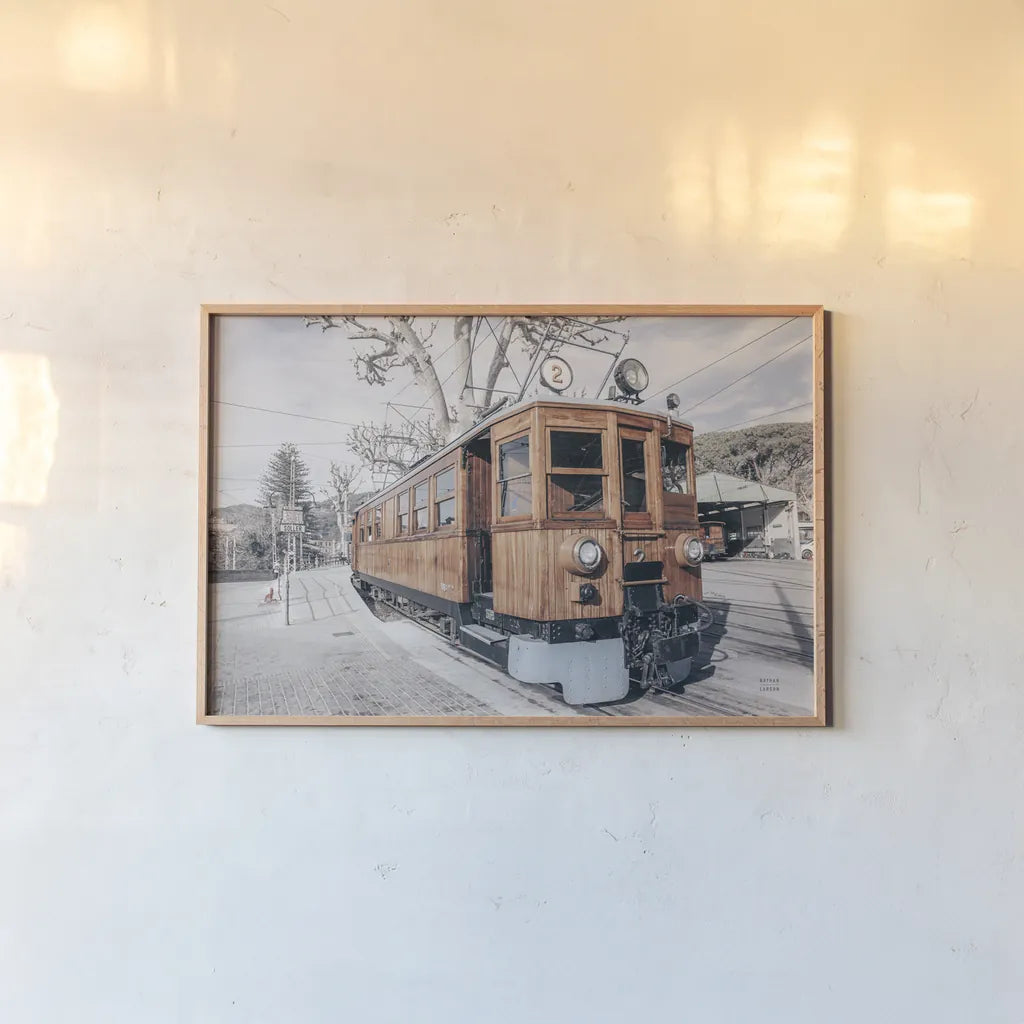 Mallorca Train Neutral by Nathan Larson. shown as a paper print in a natural frame. Available as a archival giclee rolled canvas, fine art paper, or poster print. SKU 85803i.