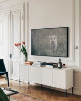 Meadow Calf by Nathan Larson. shown as a framed stretched canvas in a living room above a console. Available as a archival giclee rolled canvas, fine art paper, or poster print. SKU 89464i.