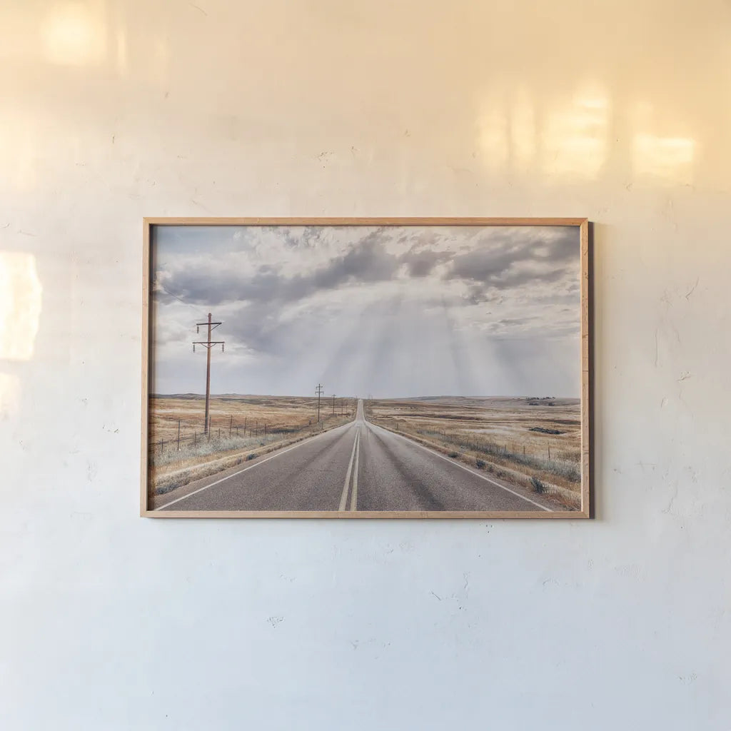 Montana Skies by Nathan Larson. shown as a paper print in a natural frame. Available as a archival giclee rolled canvas, fine art paper, or poster print. SKU 77276i.