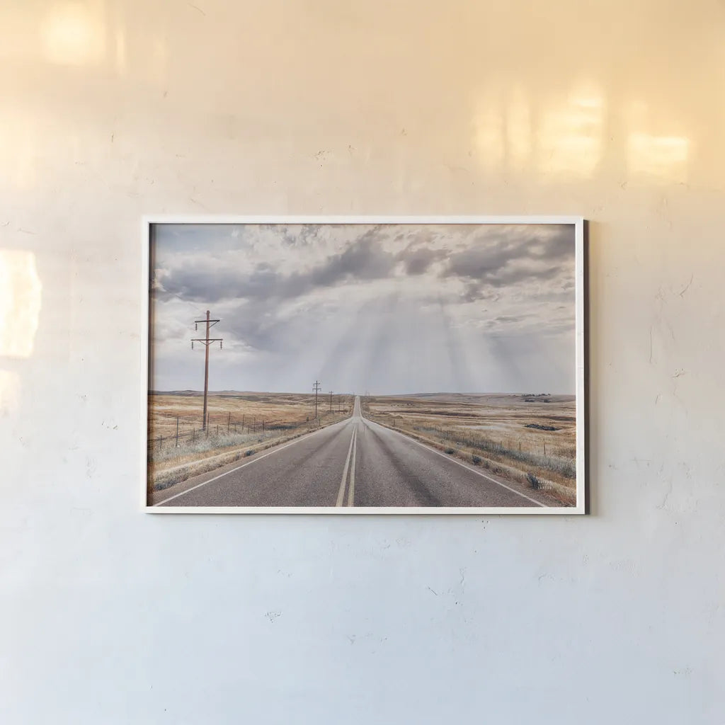 Montana Skies by Nathan Larson. shown as a paper print in a white frame. Available as a archival giclee rolled canvas, fine art paper, or poster print. SKU 77276i.