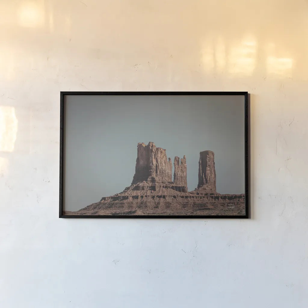 Monument Valley II by Nathan Larson. shown as a paper print in a black flame. Available as a archival giclee rolled canvas, fine art paper, or poster print. SKU 86709i.
