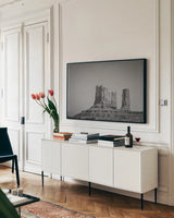 Monument Valley II BW by Nathan Larson. shown as a framed stretched canvas in a living room above a console. Available as a archival giclee rolled canvas, fine art paper, or poster print. SKU 90381i.