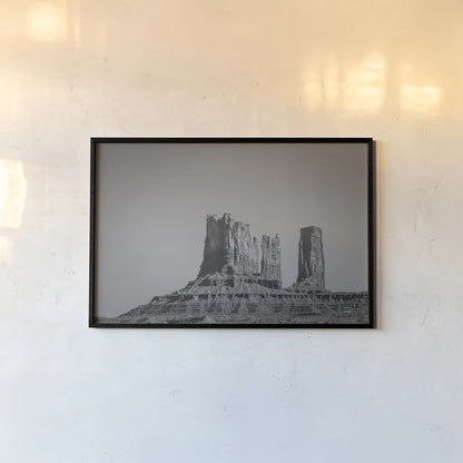 Monument Valley II BW by Nathan Larson. shown as a paper print in a black flame. Available as a archival giclee rolled canvas, fine art paper, or poster print. SKU 90381i.