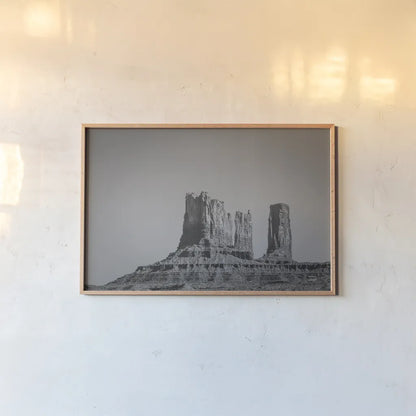 Monument Valley II BW by Nathan Larson. shown as a paper print in a natural frame. Available as a archival giclee rolled canvas, fine art paper, or poster print. SKU 90381i.