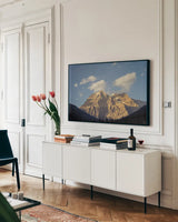 Mount Robson by Nathan Larson. shown as a framed stretched canvas in a living room above a console. Available as a archival giclee rolled canvas, fine art paper, or poster print. SKU 104558i.