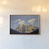 Mount Robson by Nathan Larson. shown as a paper print in a natural frame. Available as a archival giclee rolled canvas, fine art paper, or poster print. SKU 104558i.