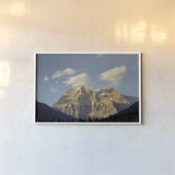 Mount Robson by Nathan Larson. shown as a paper print in a white frame. Available as a archival giclee rolled canvas, fine art paper, or poster print. SKU 104558i.