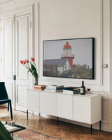 Newfoundland Foggy Morning by Nathan Larson. shown as a framed stretched canvas in a living room above a console. Available as a archival giclee rolled canvas, fine art paper, or poster print. SKU 100496i.