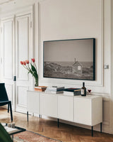 Newfoundland Historic Buildings Sepia by Nathan Larson. shown as a framed stretched canvas in a living room above a console. Available as a archival giclee rolled canvas, fine art paper, or poster print. SKU 101668i.