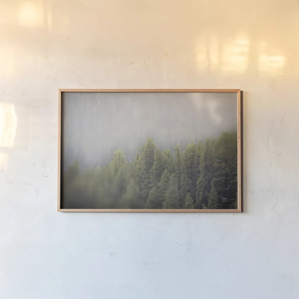 Northern Forests by Nathan Larson. shown as a paper print in a natural frame. Available as a archival giclee rolled canvas, fine art paper, or poster print. SKU 82412i.